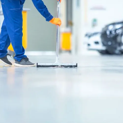 Squeegeeing a glossy service-bay floor
